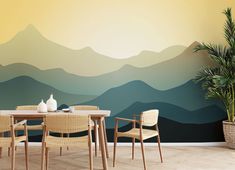 a dining room table with chairs and a wall mural