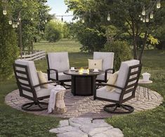 a fire pit surrounded by chairs and tables