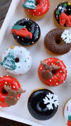 there are many decorated doughnuts in the box