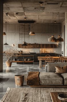 a living room filled with furniture and lots of lights hanging from the ceiling next to a kitchen