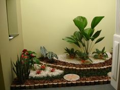 a very nice looking room with some plants and rocks in the floor by the door