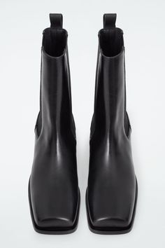 Defined by their angular shape, these modern Chelsea boots feature sharp square toes and Cuban heels. They're crafted from supple leather and designed with elasticated panels and pull tabs so you can put them on without creasing the hide. COS supports responsible manufacturing via the Leather Working Group  Upper & lining: 100% Leather. Sole: 100% Rubber. Excluding trims Heel height: 2.16" Sleek Business Heeled Boots With Square Toe, Sleek Square Toe Heeled Boots For Business, Sleek Square Toe Heeled Boots For Work, Modern Square Toe Boots With Medium Width, Elegant Square Toe Chelsea Boots For Work, Elegant Square Toe Chelsea Boots For Workwear, Calf Leather Heeled Boots With Square Toe, Modern Square Toe Chelsea Boots For Work, Modern Chelsea Boots With Square Toe For Work