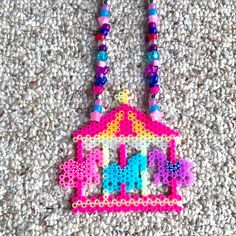 a necklace made out of beads with a carousel on it