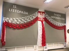 two flags are hanging on the wall in front of a sign that reads listpada