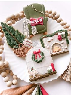 an assortment of decorated cookies on a paper plate with christmas decorations and other holiday items