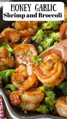 a skillet filled with shrimp and broccoli on top of a wooden spoon