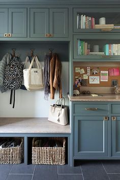 a kitchen with blue cabinets and baskets on the counter