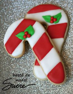 two decorated cookies sitting on top of a table