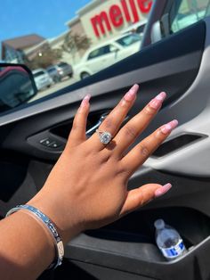 a woman's hand on the dashboard of a car