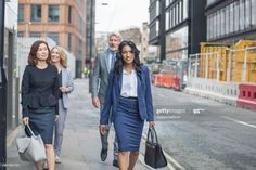 three business people walking down the street