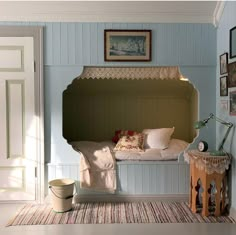 a room with a bed and pictures on the wall, including an old fashioned bench