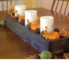 some candles are sitting on a wooden table