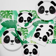 panda face plates and napkins with green leaves on the table top, set of four