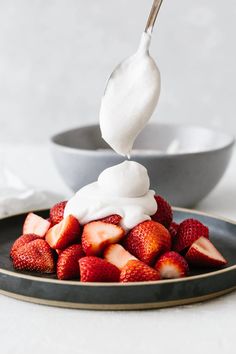 strawberries and whipped cream are on a plate