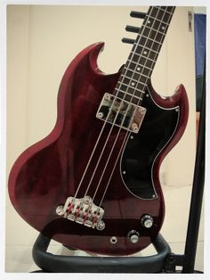 an electric bass guitar on display in a museum