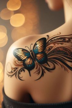 the back of a woman's shoulder with a butterfly tattoo on it