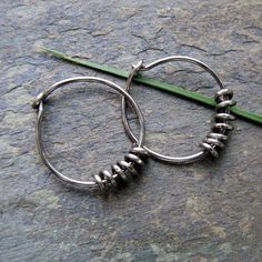 "Niobium works for super-sensitive ears, which cannot tolerate silver, gold or surgical steel. It needs no special care. I hand form these simple gunmetal hoops out 18 gauge (1.02mm) niobium wire. I smooth the tips and decorate the earrings with a simple free-floating niobium coil. Connect to the thread of artistic personal adornment anchored in humanity's origins with these simple everyday hoops. 12mm/.5\" in diameter. Shown in 18g, 20g and more delicate 22g. Check here for the 20g version: htt Mens Hoop Earrings, Earring Inspiration, Golden Copper, Mens Earrings Hoop, Diy Jewlery, Earring Ideas, Nose Hoop, Earrings Inspiration, Recycled Sterling Silver