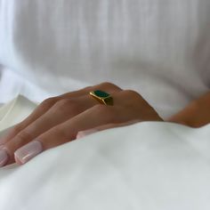 Explore the benefits of this Natural Malachite Ring by Asana. This unique piece of jewelry is perfect for anyone who wants to add a touch of spirituality and protection to their look. The ring is made of natural stone with a metal band, and it features an 18k gold plating. The stone is said to be spiritually protective, and it's a beautiful shade of green. Whether you're looking for a new piece of mystic jewelry to add to your collection or a special meaningful gift for someone, the Malachite Ri Gemstone Ring For Meditation, Gold Emerald Ring With Spiritual Style, Spiritual Gold Emerald Ring, Spiritual Gold Emerald Ring With Gemstone, Spiritual Gold Rings With Natural Stones, Gold Emerald Signet Ring Gift, Yellow Gold Malachite Ring Gift, Minimalist Gold Turquoise Gemstone Ring, Minimalist Gold Turquoise Ring As Gift