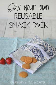 some cookies and strawberries on a blue towel with the words sew your own reusable snack pack