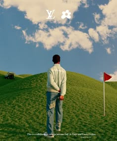 a man standing on top of a lush green field next to a red golf ball