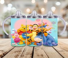 winnie the pooh and friends mugs on a wooden table with blurry background