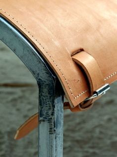 a close up of a leather seat on a chair