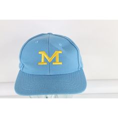 a blue hat with the letter m on it