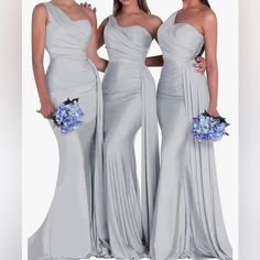 three bridesmaids in long silver dresses posing for the camera