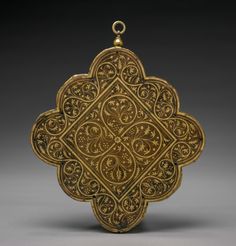 an ornately decorated gold object with filigrees