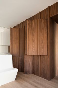 an empty room with wood paneling on the walls