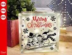 a glass block with an image of two cartoon characters on it and the words merry christmas