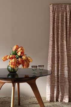 a glass table with some flowers on it