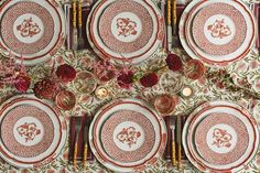 the table is set with red and white plates