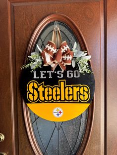 this is a door sign for the pittsburgh football team that has been decorated with flowers