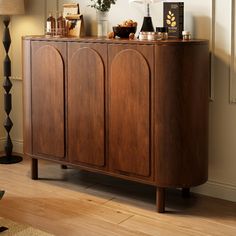 a large wooden cabinet sitting next to a lamp