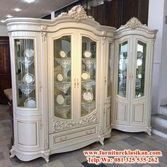 an antique china cabinet with glass doors