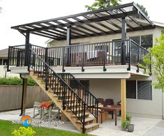 an outdoor patio with stairs leading up to the second floor