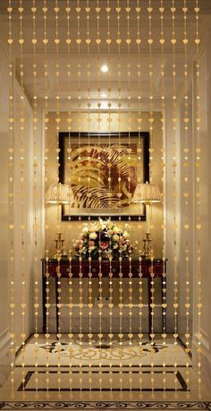 an elegant hallway decorated in gold and white