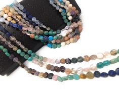 multicolored beaded necklaces on black leather case