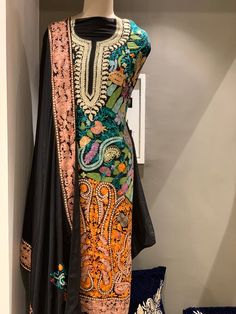 A stunningly marvellous outfit featuring Kashmiri Aari and Tilla fusion Embroidery. - - - - - - - - - - - - - - - - - - - - Product Details- Condition: Brand New (made to order)- Dress Style: Indian Salwar Suit- Embroidery: Kashmir Aari & Tilla Work- Base Color: Black- Embroidery Color: Multi-ColourF A B R I CShirt: Viscose GeorgetteDupatta: ChiffonLower: Indian CrepeF I N I S HUnstitched/Semi-StitchedYou can get it stitched locally.47+ inches of Shirt Length and up to full sleeves length.St Designer Multicolor Dress With Intricate Embroidery, Transitional Season Fitted Multicolor Embroidered Fabric, Transitional Multicolor Fitted Embroidered Fabric, Fitted Embroidered Chinon Salwar Kameez, Multicolor Silk Dress With Intricate Embroidery, Traditional Designer Dress With Multicolor Embroidery, Festive Multicolor Anarkali Set With Intricate Embroidery, Designer Multicolor Embroidery Dresses For Festivals, Bollywood Style Multicolor Dresses With Intricate Embroidery