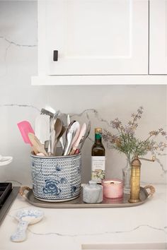 kitchen utensils in blue and white container on counter