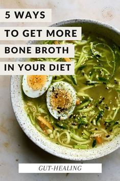 a bowl filled with broccoli, noodles and hard boiled eggs on top of it