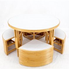 a round table with four stools around it on a plain white surface in front of a white background