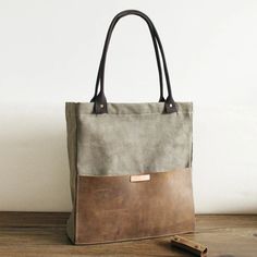 Canvas Leather Tote Bag Handcrafted Canvas Shoulder Bags Canvas And Full Grain Leather Shopper Bag 14051 Model Number: 14051 Dimensions: 18.9"L/Top / 15.7"L/Bottom x 3.1"W x 15.7"H / 48 cm(L/Top) / 40 cm(L/Bottom) x 8 cm(W) x 40 cm(H) Weight: 1.8 lb / 0.82 kg Material: Canvas And Full Grain Leather Shoulder Strap: With Color: Coffee / Army Green Features: • Canva and Genuine Natural Leather• Inside 1 Cell Pocket, 1 Wallet Pocket, 1 Zipper Pocket• YKK Zipper• Shoulder Strap• Can fit a 15.6'' Lapt Leather Canvas Bag, Waxed Canvas Tote Bag, Canvas Leather Tote Bag, Tote Bag With Pockets, Leather Shopper Bag, Waxed Canvas Bag, Canvas Leather Tote, Leather Tote Bag Women, Canvas Leather Bag