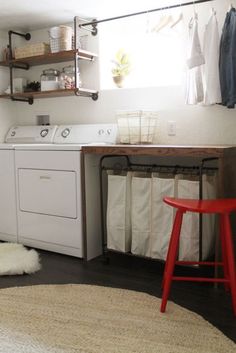 a washer and dryer sitting in a room next to a table with two chairs