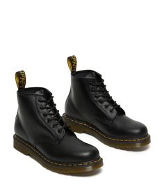 The Dr. Martens® 101 Yellow Stitch boots embodies all the classic clean lines, standout stitching, and edgy attitude of the vintage utilitarian work boot, but in a lower-cut design and a smooth leather construction..Lace-up boots have a smooth leather construction made of a firm, finished leather with a smooth, semi-bright appearance..Six-eyelet boot with sturdy fabric laces for a secure fit..Features classic Doc's DNA including grooved edges, a yellow welt stitch, and a scripted heel loop..Good Casual Ankle Combat Boots For Work, Classic Moto Boots With Lug Sole And Round Toe, Classic High-top Martin Boots For Fall, Classic Moto Boots With Lug Sole, Classic Fall Boots With Lug Sole, Casual High-top Moto Boots For Work, Classic Fall Moto Boots With Lug Sole, Classic Moto Boots With Lug Sole For Fall, Classic Waterproof Boots With Reinforced Toe For Work