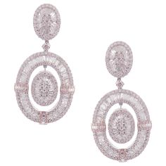 These modern oval baguette earrings are crafted in 18-karat white gold, weighing approximately 14.65 total carats of SI-V Quality white diamond. French Clip backing. Beautiful rose gold accent. Our Ballroom Collection feature earrings for those with bold/classy aesthetics and elegant tastes. 346 Round Diamonds = 7.84 ct 235 Baguette Diamonds = 6.81 ct Luxury Classic Linear Earrings In Diamond White, Luxury Elegant White Linear Earrings, Baguette Earrings, Baguette Earring, French Clip, Rose Gold Accents, Diamond Dangle Earrings, Circle Diamond, White Gold Earrings