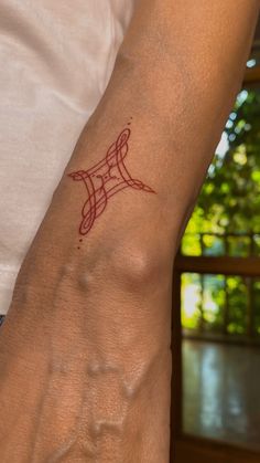 a person's arm with a tattoo on it that has the word love written in red ink