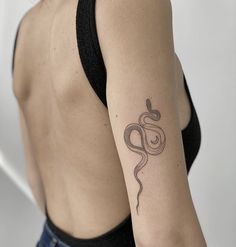 a woman's arm with a snake tattoo on the left side of her body