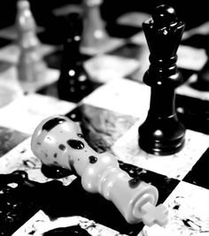 black and white chess pieces on a checkered board